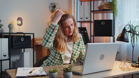 displeased sad office woman using laptop working loses bad news computer virus fail loss game