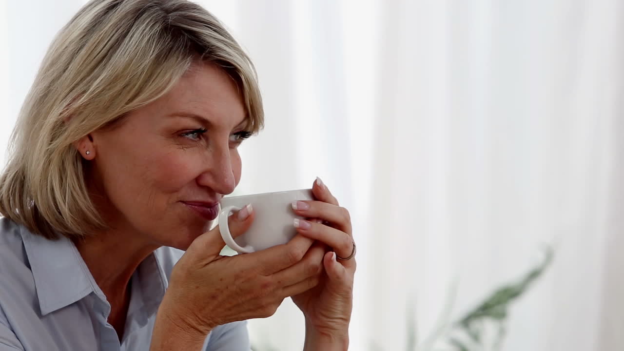 Relaxed woman drinking a cup of tea