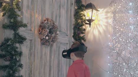 schoolboy adjusts vr glasses on head and looks in camera