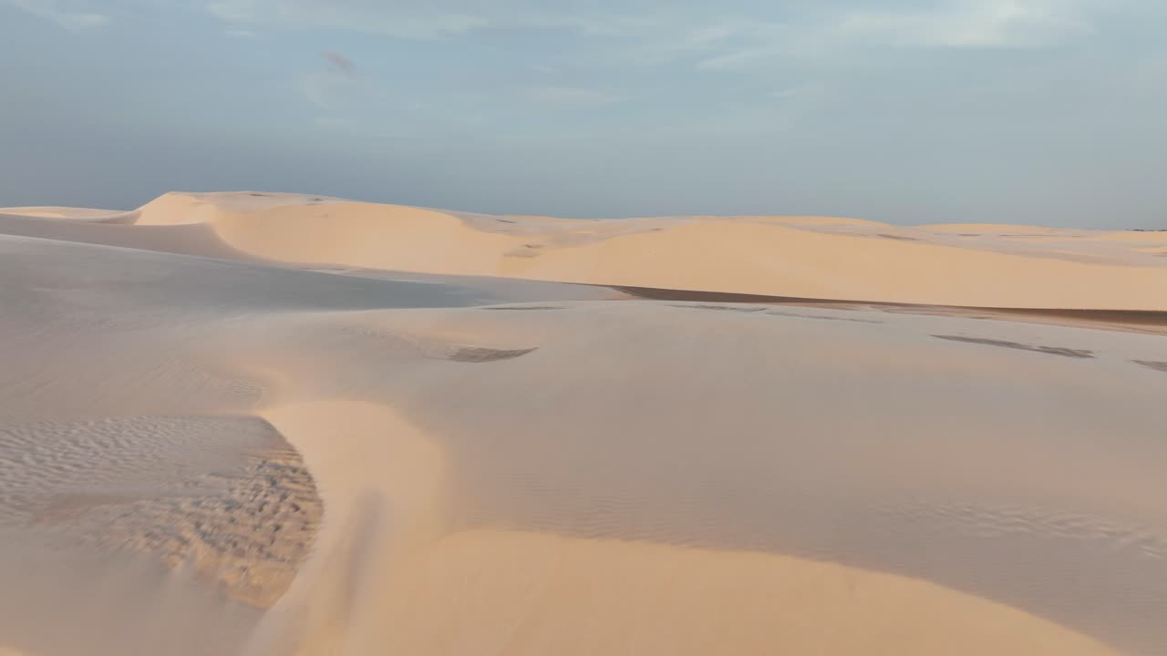 Push in drone shot of sand dunes in Lencois Maranhenses National Park during the day in Maranhao state, northeastern Brazil