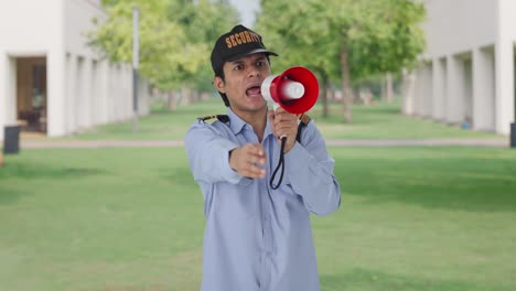 angry indian security managing crowd using megaphone