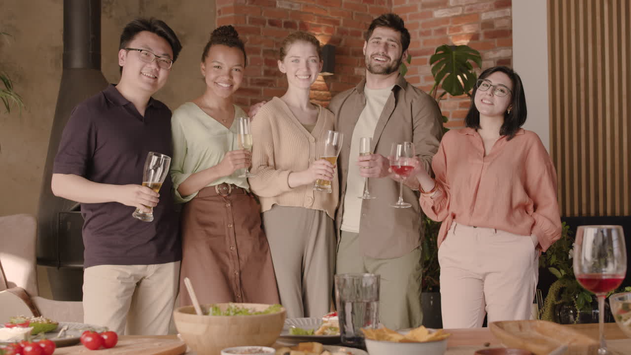 저녁 파티에서 카메라를 보고 웃고 있는 다문화 친구들