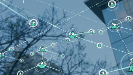 animation of network of profile icons against low angle view of tall building and tree