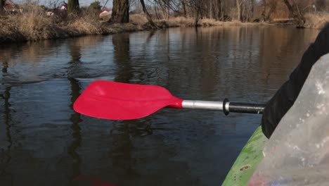 kayak paddle water drops.red paddle close-up