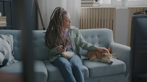 woman and dog relaxing on couch