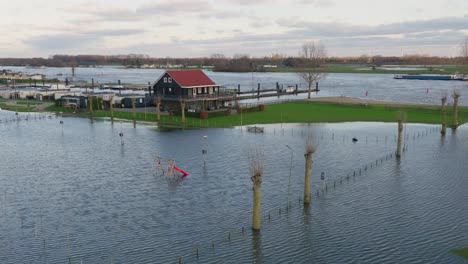 flooded campsite on banks of river lek in utrecht, netherlands