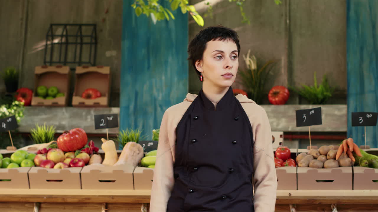 A produce vendor selling fruits and vegetables at a market stall