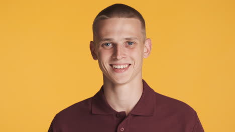 happy blond man smiling, looking at front