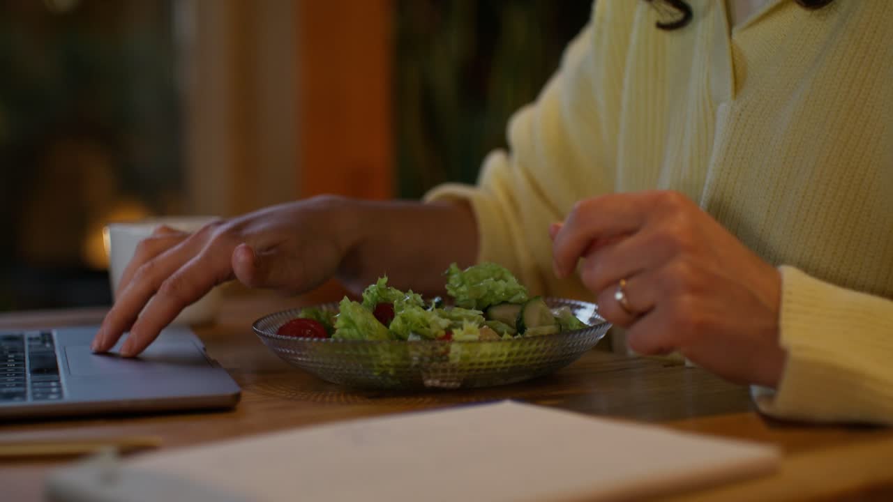 Woman Eating Salad at Laptop