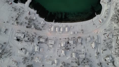 Top-down-rising-shot-of-the-small-lake-front-village-of-ersfjordvegen,-Norway