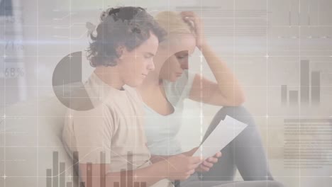 animation of infographic interface over worried caucasian couple discussing pending bills at home