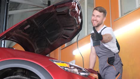 auto mechanic working on car and giving thumbs up