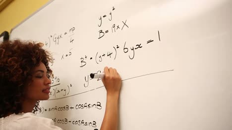 Clever student solving math problems on whiteboard