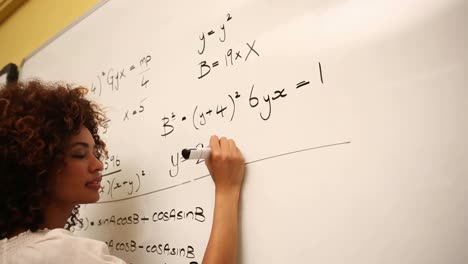 clever student solving math problems on whiteboard