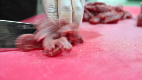 4k: chef cutting raw meat on a cutting board in a professional kitchen-2