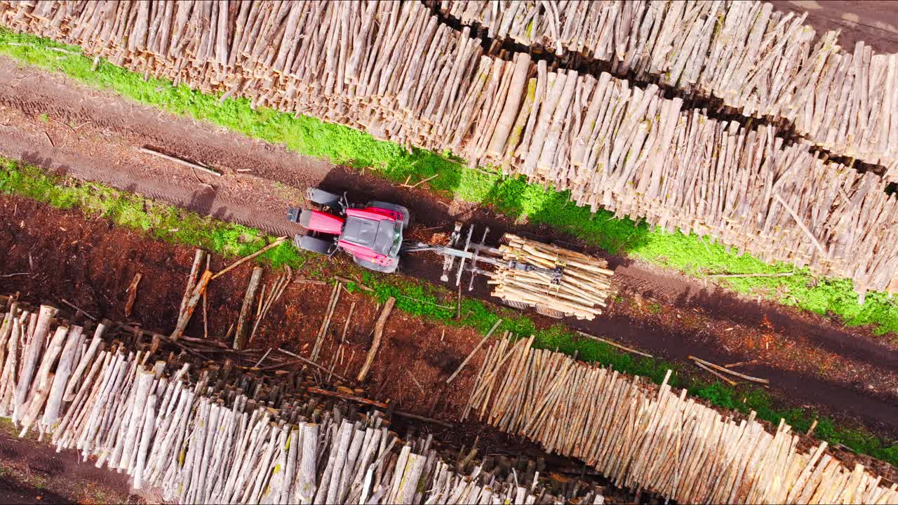 Drone top down view logging site tractor moving timber slow rotation