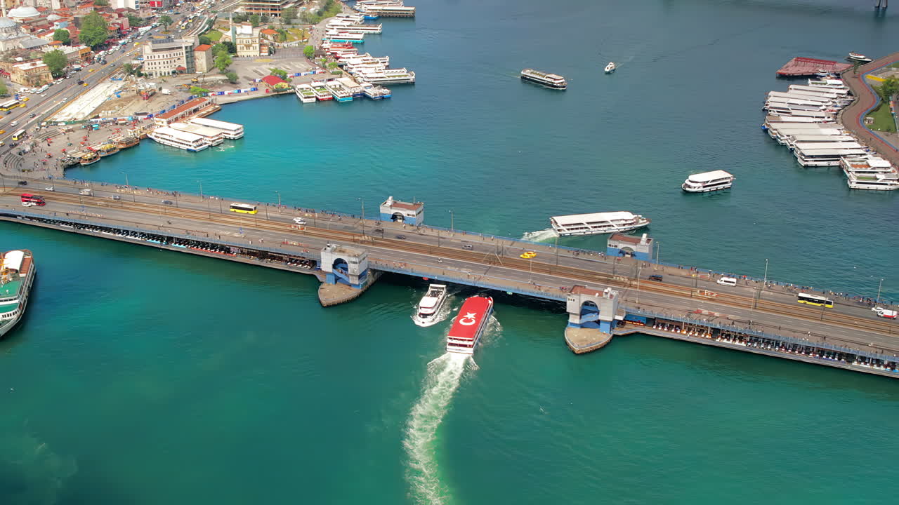 Aerial drone view of Istanbul, Turkey. Galata and Metro bridges with moving cars over the Golden Horn waterway with multiple floating ships