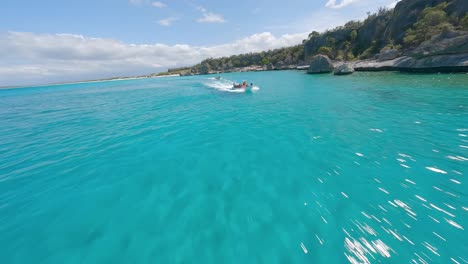 Spectacular-fpv-drone-flight-over-blue-colored-Caribbean-Sea-and-rocky-coastline-during-sunlight