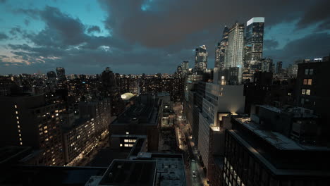 manhattan, new york skyline at night with bustling streets, moving cars, pedestrians, and dark clouds overhead