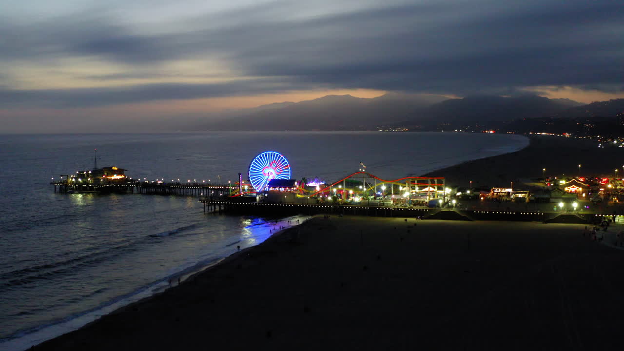 Santa Monica Pier at Dusk with Illuminated Ferris Wheel and Pacific Ocean