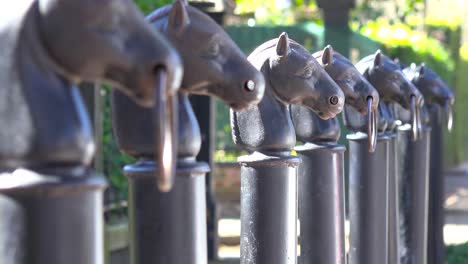 horse head hitching posts line a street in new orleans