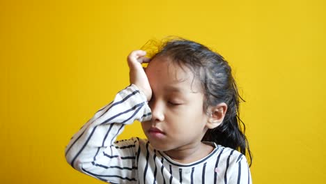 a upset child girl looking down ,