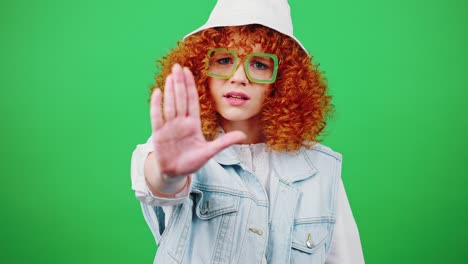 please, stop. young curly redhead woman wearing eyeglasses and panama hat making stop gesture to camera