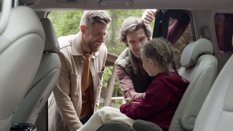 family getting ready to travel on big car