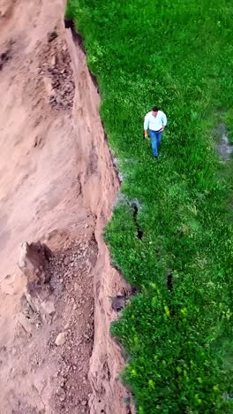landslide and man near the riverbank
