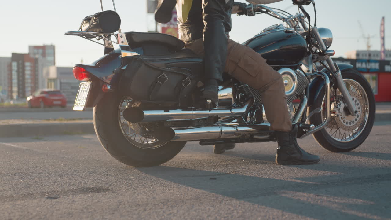 Woman waits for biker friend, climbs motorcycle, holds him closely, and rests her head on his shoulder, scene captures bond, intimacy, and lifestyle of bikers with blurred background