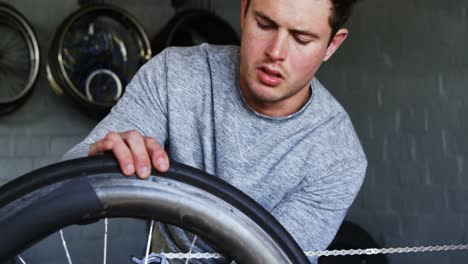 Disabled-man-repairing-wheelchair-at-workshop-4k