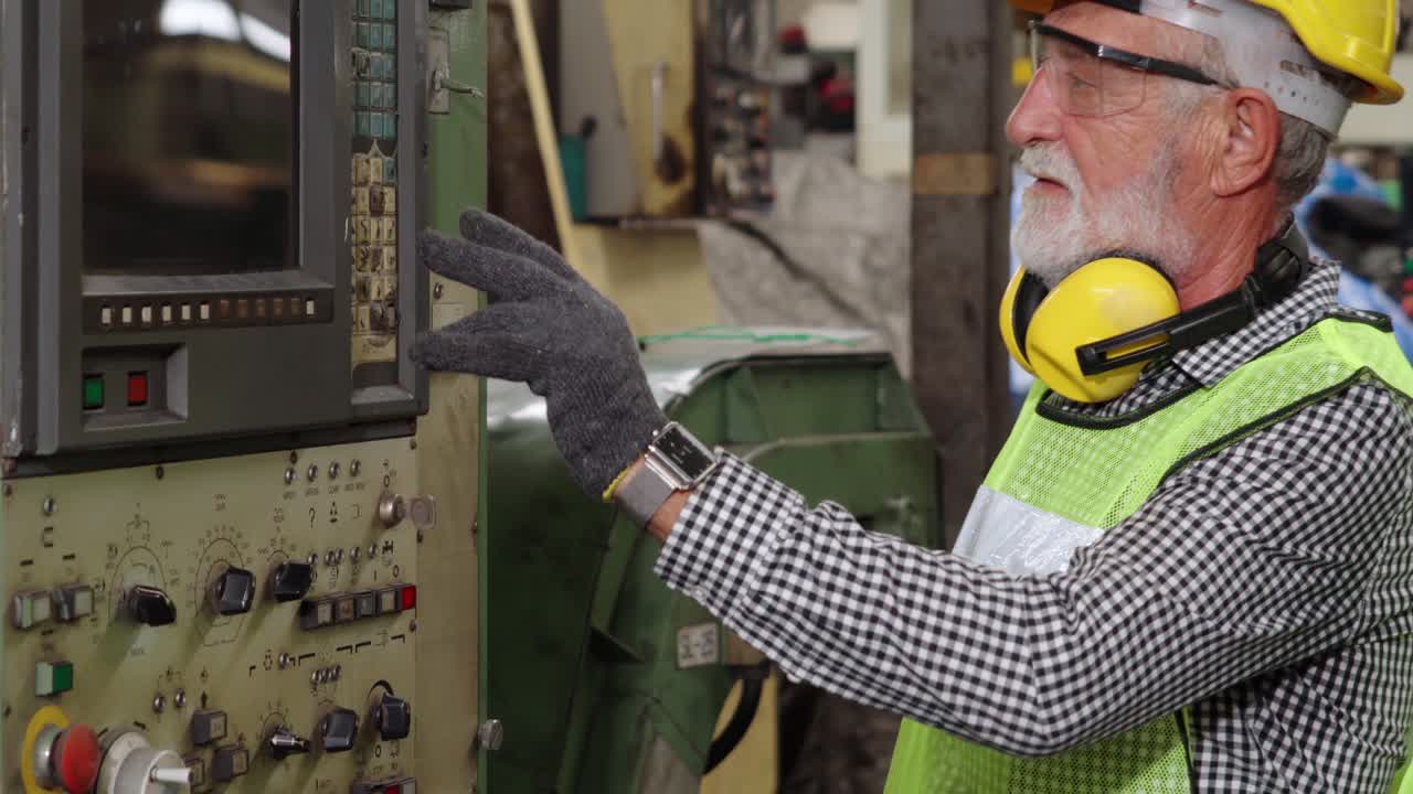 Senior factory worker teach how to use machine equipment in the factory workshop
