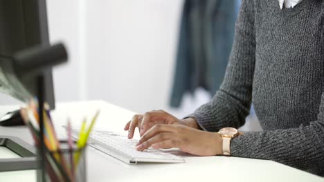 Young-Woman-Typing-on-Computer-at-Desk