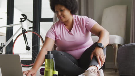 video of midsection of plus size african american woman in sport clothes preparing for exercising