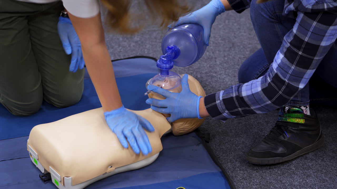 Medical dummy doll lays on blue blanket ready for training. First medical help with oxygen masks. First aid help.