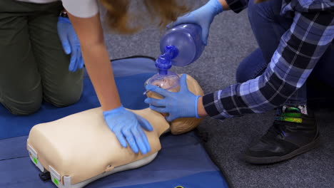 medical dummy doll lays on blue blanket ready for training. first medical help with oxygen masks. first aid help.