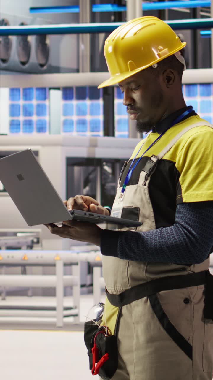 Vertical video Smart factory specialist, testing automated systems, monitoring production