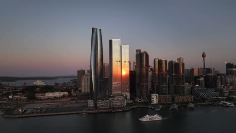 darling harbour waterfront and barangaroo at dusk in sydney, australia - aerial pullback