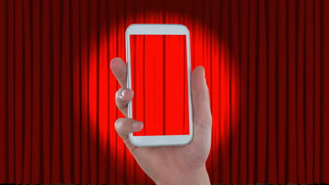 mano con un teléfono móvil y videos en lcd