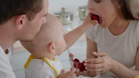 family enjoying strawberries in the kitchen