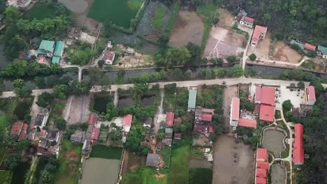 Vista-Aérea-De-Un-Resort-En-Un-Pueblo-Vietnamita-Y-Los-Arrozales-Circundantes