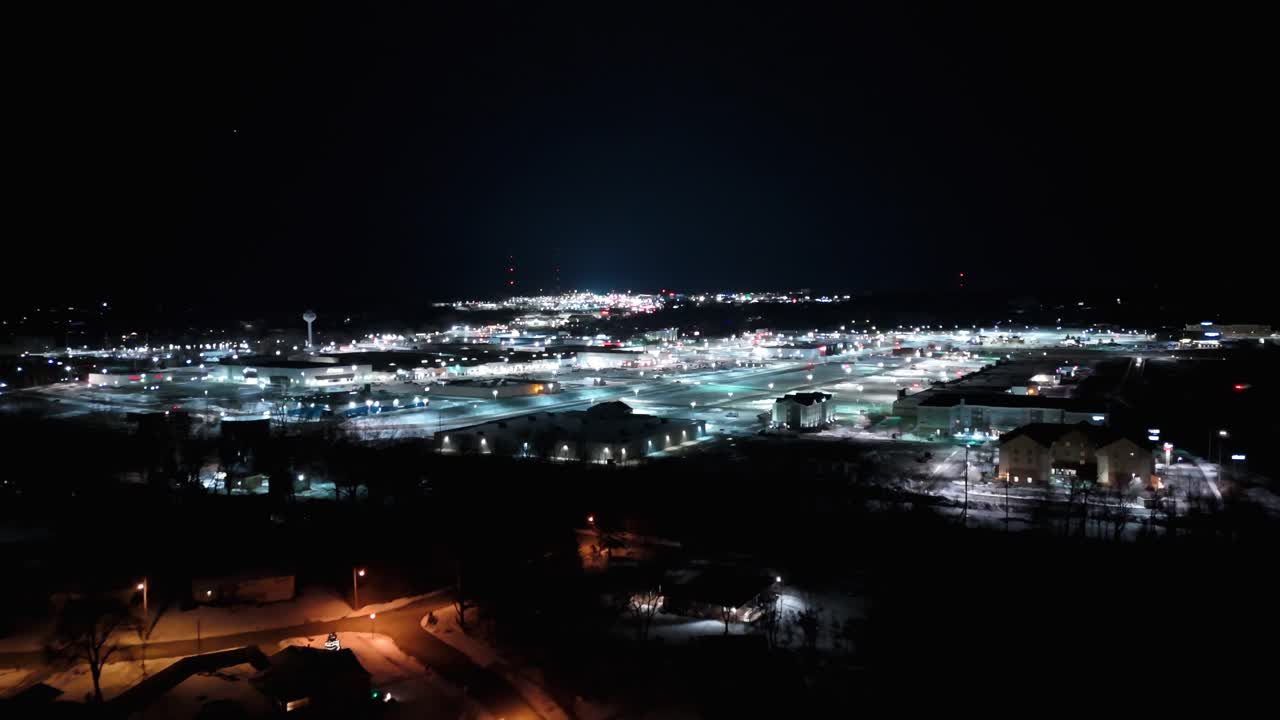 Aerial close up of The Millcreek mall at night in the winter in Erie, PA.