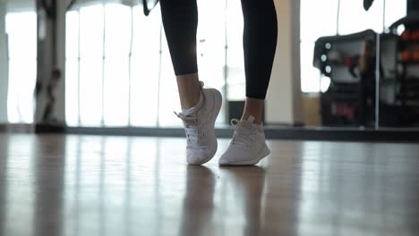 a dynamic shot of a woman in stylish white sneakers, showcasing the essence of fitness and modern gym culture