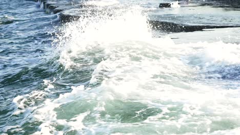 wave and drops at the beach. beautiful wave crashing on rocks in sea with big splash