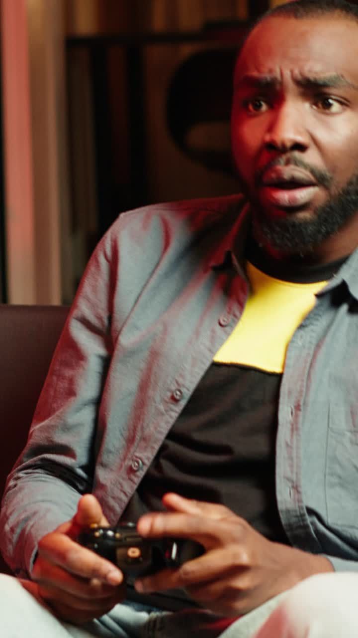 Vertical video Man putting face in hands in frustration after being defeated in videogame