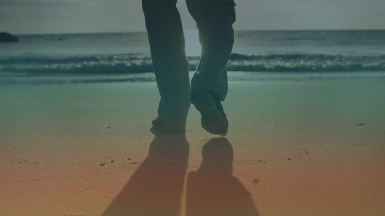 Senior man walking on wet sand, stepping toward surf while animated footprints marking travel range