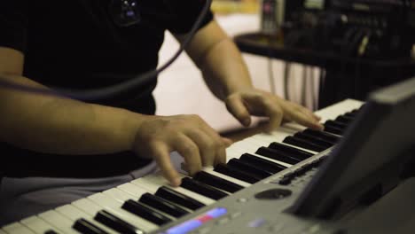 musician playing on his keyboard