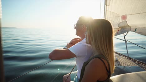 couple sailing on a yacht at sunset