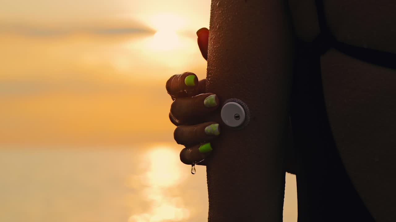 Slow motion sunset shot of woman touching CGM sensor symbolizing care inequality