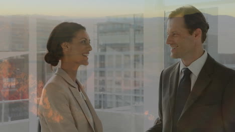 animation of cityscape over diverse business people working at office